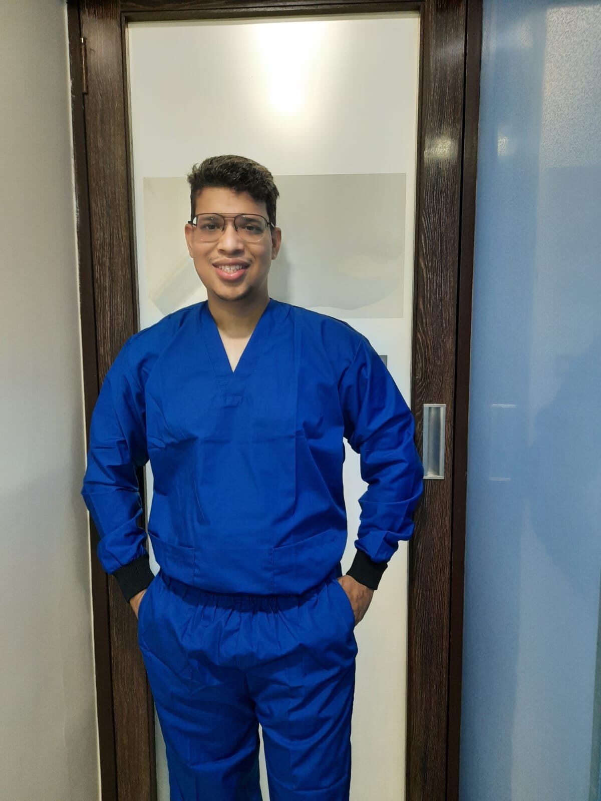 Dr. Prit Shah wearing blue surgical scrubs